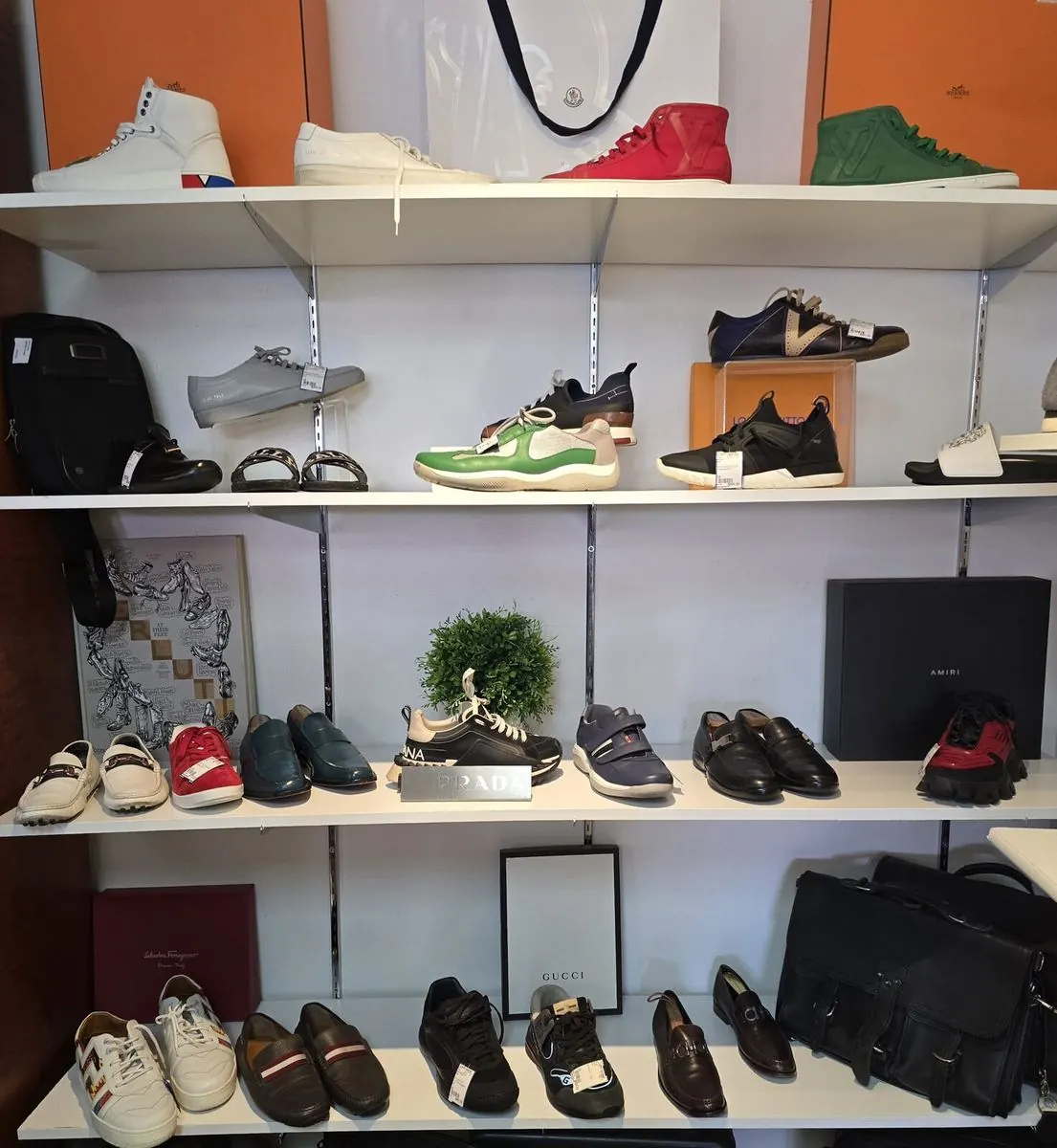 Shelves of designer sneakers and loafers from Louis Vuitton, Prada and Gucci