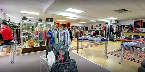 Accessory cases and rows of sport coats in the showroom