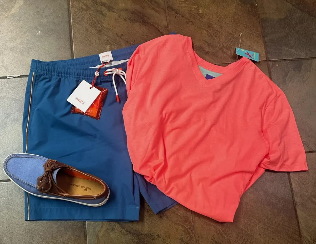 Blue SWIMS swim shorts paired with a coral tee and Peter Millar boat shoes