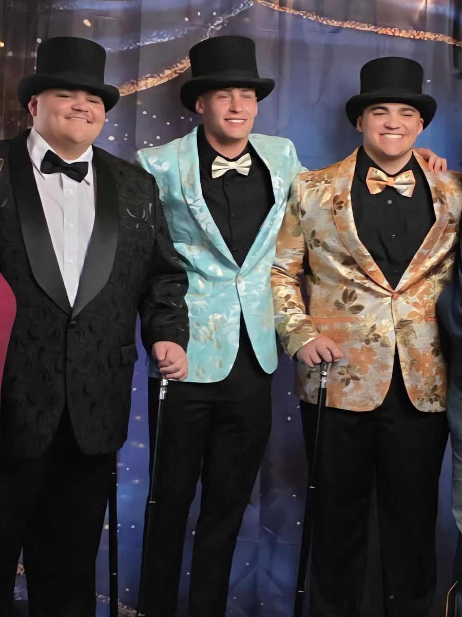 Three men in patterned tuxedo dinner jackets and top hats from Label Legends