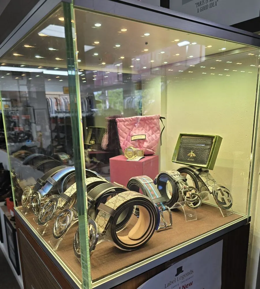 Gucci belts, card case and handbag in the showroom display case