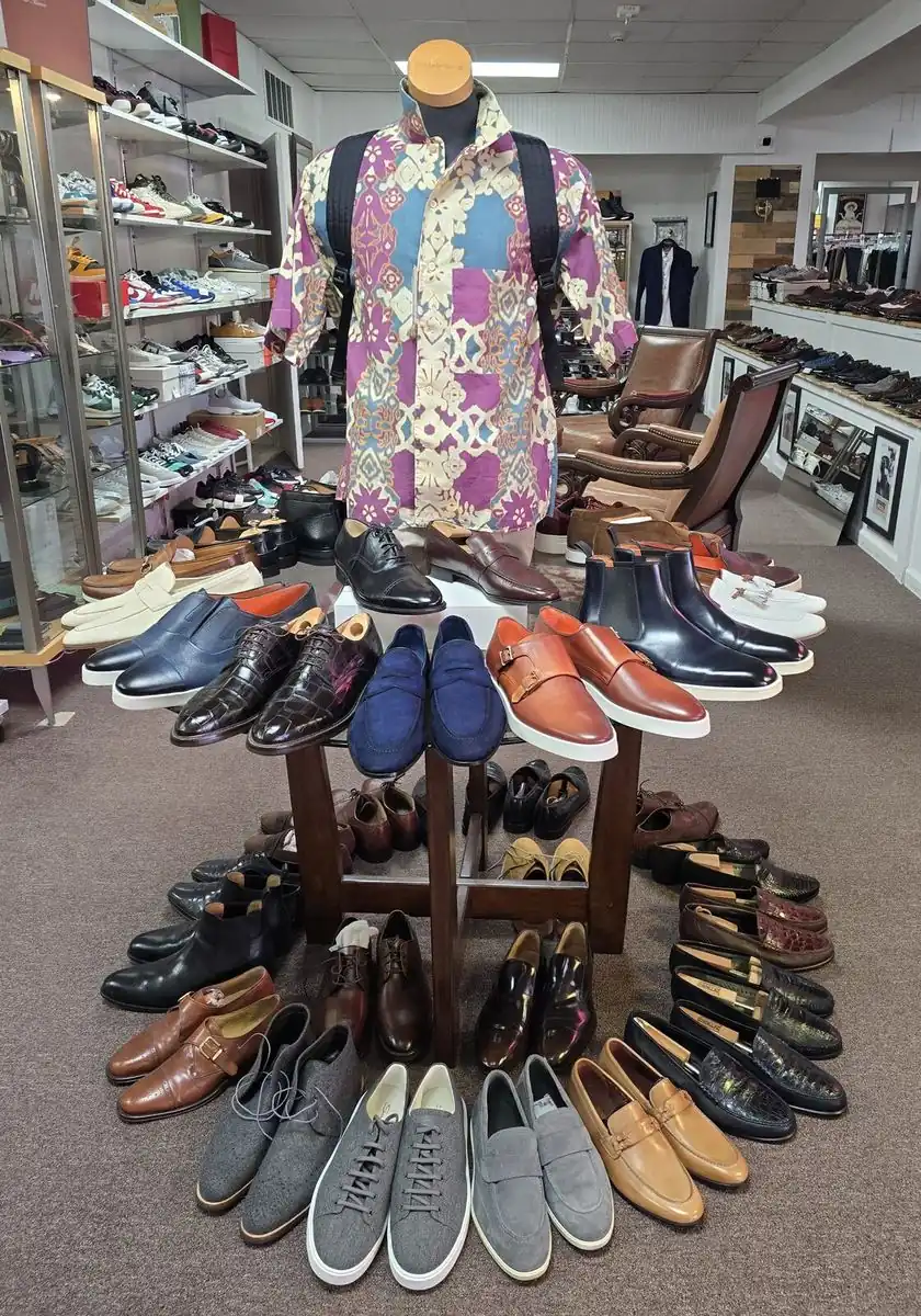 Dress shoes, loafers and sneakers arranged around a mannequin in the Label Legends showroom