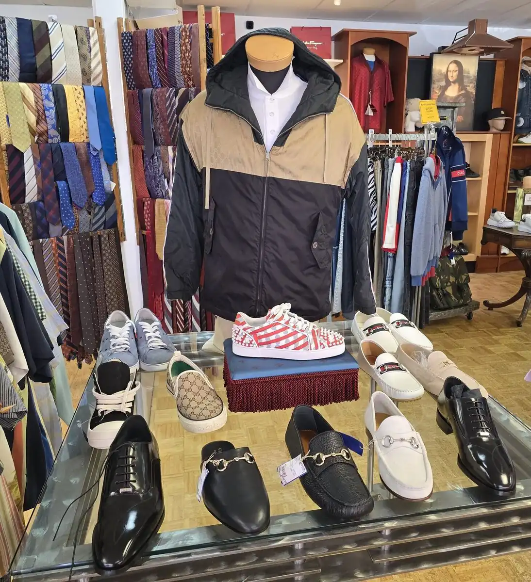 Gucci loafers, drivers and designer sneakers on a glass display case