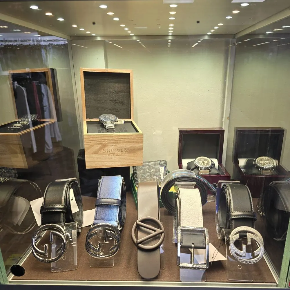 Designer belts, watches and small leather goods in the display case