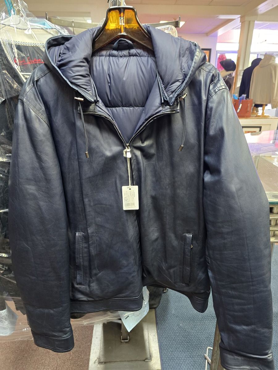 Navy quilted jacket with leather sleeves on a mannequin in the Label Legends showroom