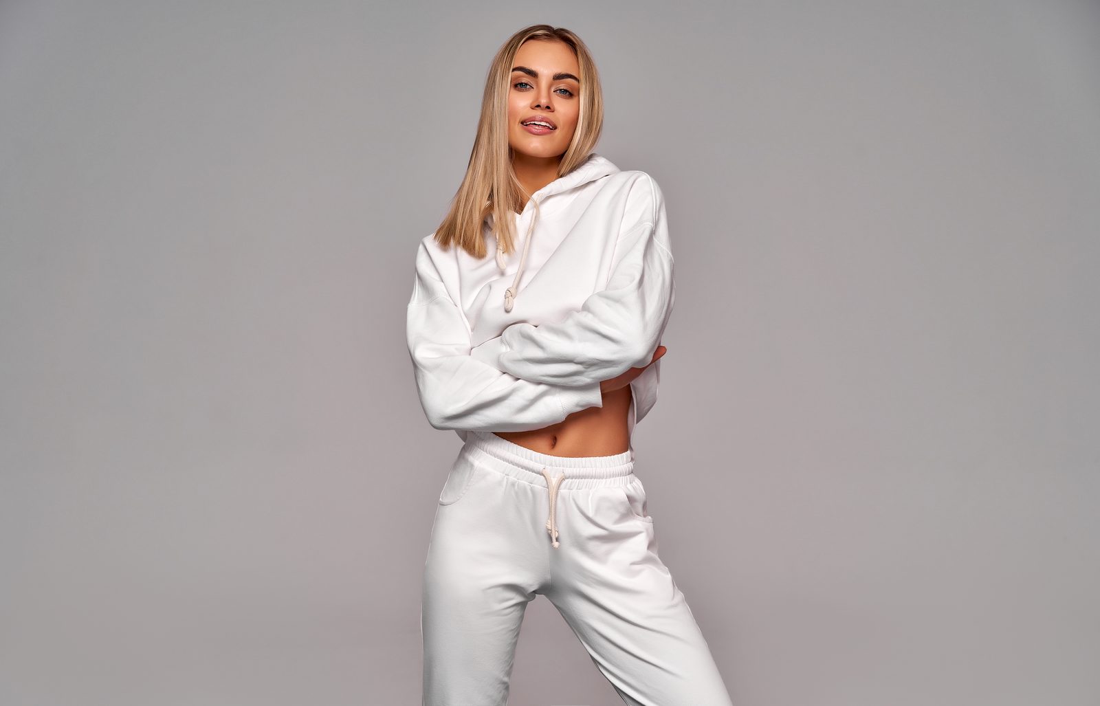 Woman in a white hoodie and matching joggers