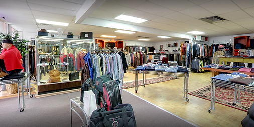 Accessory cases and rows of sport coats in the showroom