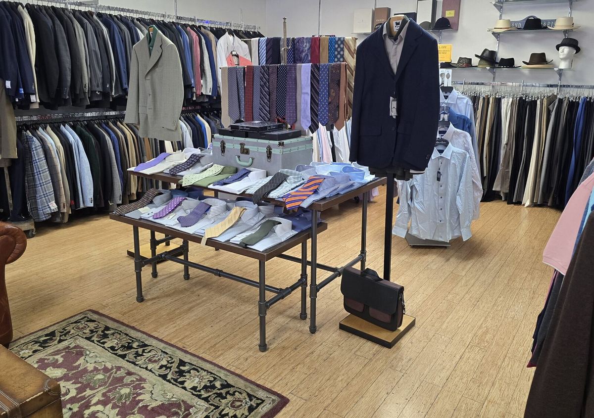 Inside the Label Legends showroom in Farmington Hills — tie bar, dress shirts and suit racks