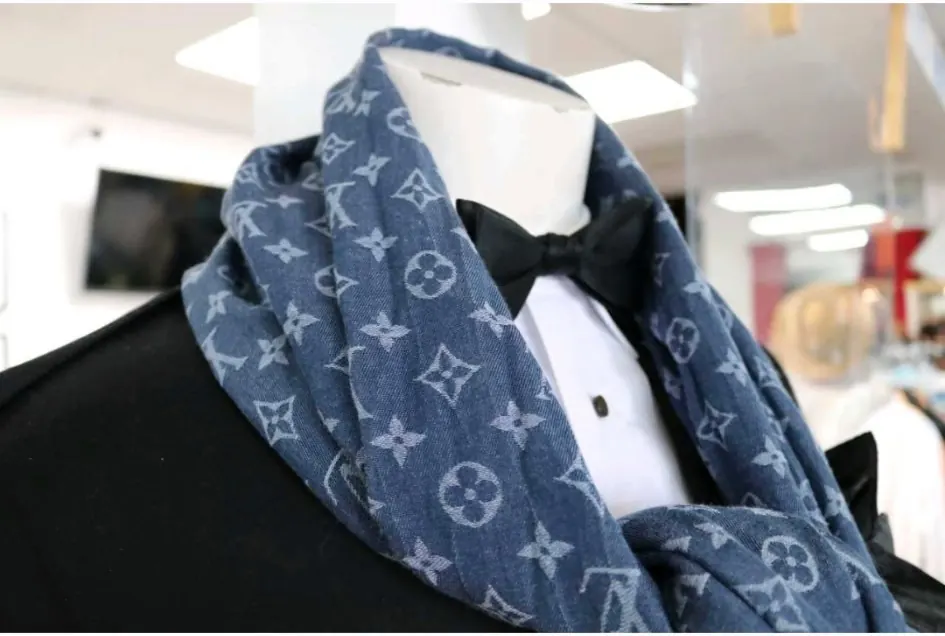 Louis Vuitton monogram scarf styled with a tuxedo and black bow tie