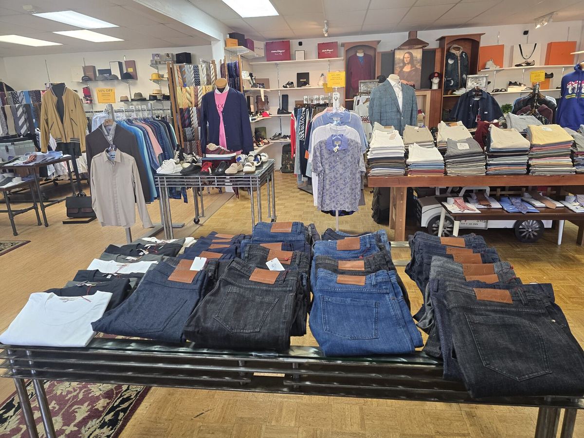 Inside the Label Legends showroom in Farmington Hills — folded designer denim and menswear tables