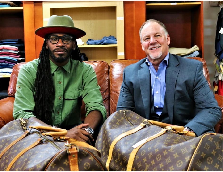 Two customers with Louis Vuitton luggage in the Label Legends showroom