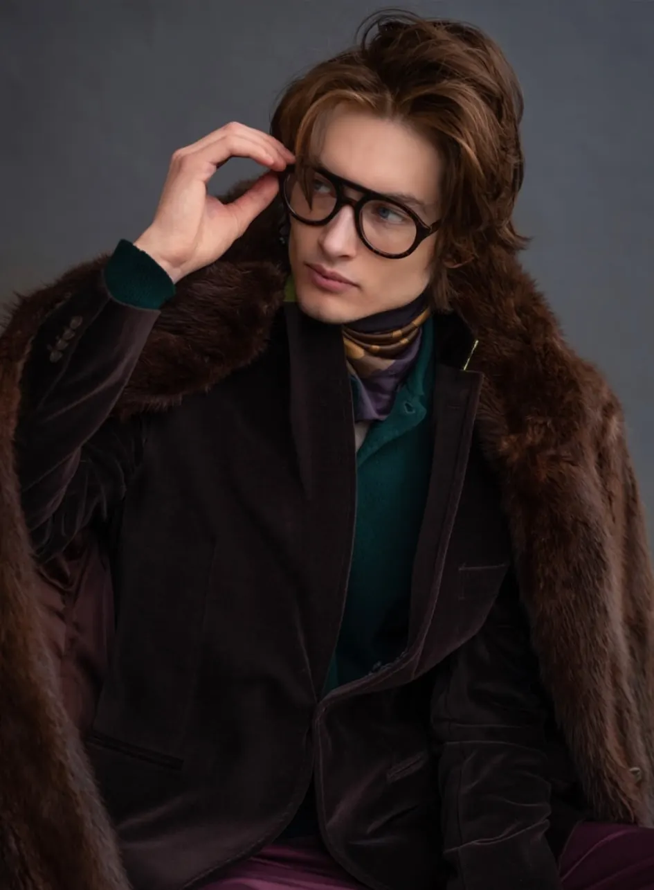 Brown velvet blazer layered under a fur-collared coat