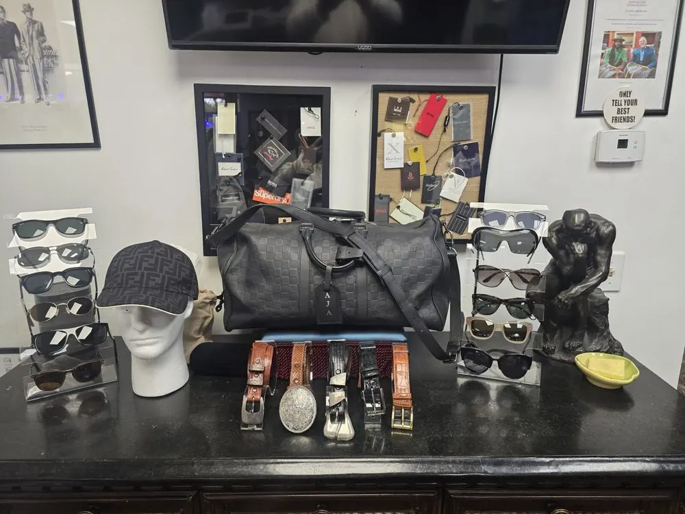 Designer sunglasses, Fendi cap, Louis Vuitton duffle and belts at Label Legends